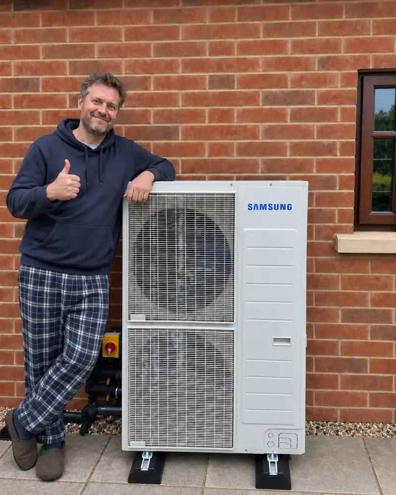 Happy Get Free Quote customer with an installed air source heat pump